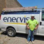 Worker standing in front of an Enervise truck