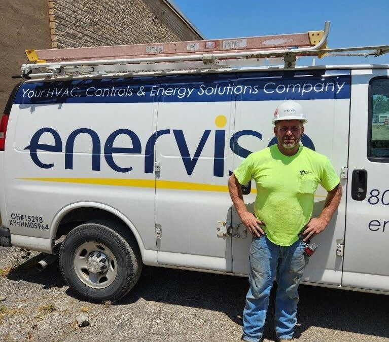 Worker standing in front of an Enervise truck